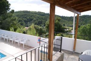 a balcony with chairs and a view of the mountains at Villa Elpiniki in Troulos