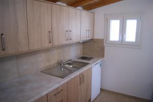 a kitchen with a sink and a window at Villa Elpiniki in Troulos