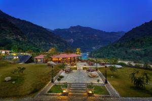 an aerial view of a resort with a river and mountains at Aloha On The Ganges by Leisure Hotels in Rishīkesh