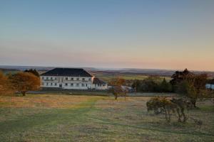 a large white building in the middle of a field at The Moorland Hotel in Wotter