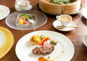 a wooden table with plates of food on it at Aura Tachibana in Hakone