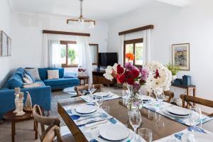 a living room with a table and a blue couch at Villa Filoxenia 1937 in Gerani Chanion