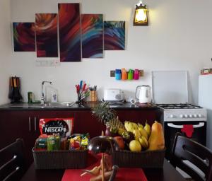 a kitchen with a table topped with baskets of fruit at Best Inn Villa Mirissa in Mirissa