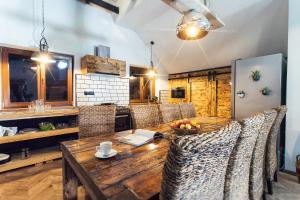 a kitchen with a wooden table and chairs at Kopec 67 in Štramberk