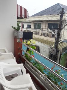 a balcony with white sinks and plants on it at Jenny Hostel HuaHin in Hua Hin