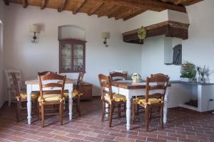 a dining room with a table and chairs at Podere La Contessa B&B in Prato