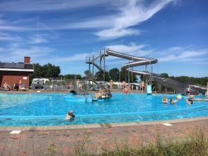 a group of people in a pool at a water park at Dancamps Trelde Naes (Camp Site) in Fredericia