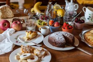 a table with plates of pastries and fruit on it at Podere La Contessa B&B in Prato