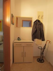 a room with a counter with a jacket hanging on the wall at Apartment Freynik in Göttingen