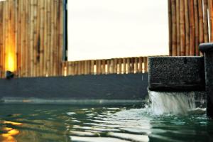 a pool of water coming out of a fountain at Azumaya Hotel Phnom Penh in Phnom Penh