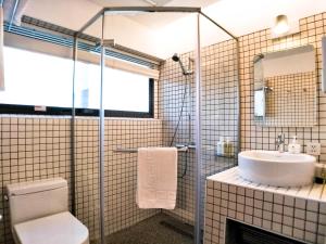 a bathroom with a toilet and a sink at Dayspring Inn in Nangan