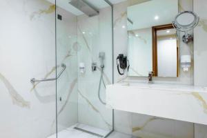 a bathroom with a sink and a shower at Hollywood Hotel in Sarajevo