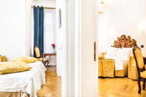 a bedroom with two beds and a table at Charles Bridge Palace in Prague