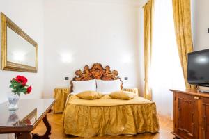 a bedroom with a bed with a gold bedspread at Charles Bridge Palace in Prague