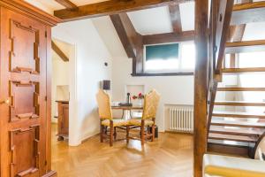 a kitchen and dining room with a table and chairs at Charles Bridge Palace in Prague
