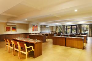 a large dining room with tables and chairs at Aloha On The Ganges by Leisure Hotels in Rishīkesh
