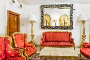 a room with two chairs and a mirror at Charles Bridge Palace in Prague
