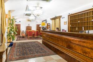 a woman sitting at a bar in a room at Charles Bridge Palace in Prague