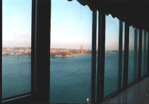 a window with a view of the water and a city at Ferienwohnung-im-Wikingturm in Schleswig