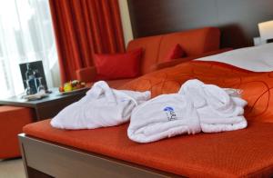 Postel nebo postele na pokoji v ubytování Aribo Hotel