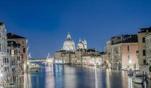 a view of a river with buildings and a cathedral at Luxury Venetian Rooms in Venice
