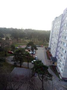 a view of a parking lot between two buildings at Apartment near the Sea in Ventspils