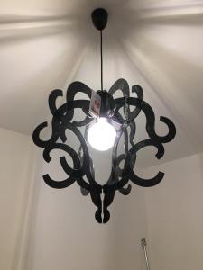 a black chandelier hanging from a ceiling at Casa America in Montesilvano Marina