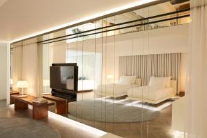 A television and/or entertainment centre at Nikki Beach Resort & Spa Porto Heli