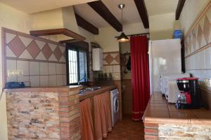a kitchen with a brick counter top in a room at Casa Rural Las Adelfas in El Gastor