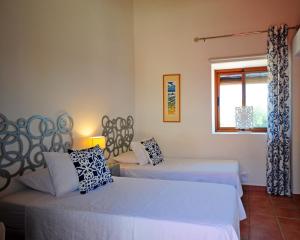 a bedroom with two beds and a window at La Fuente Retreat in Lecrin