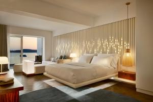 A bed or beds in a room at Nikki Beach Resort & Spa Porto Heli