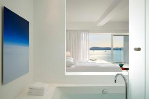 A bed or beds in a room at Nikki Beach Resort & Spa Porto Heli