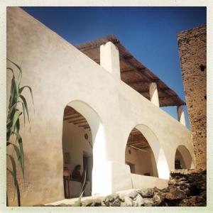 an external view of a building with arches at casa 3 archi in Alicudi +11 photos