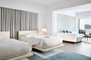 A bed or beds in a room at Nikki Beach Resort & Spa Porto Heli
