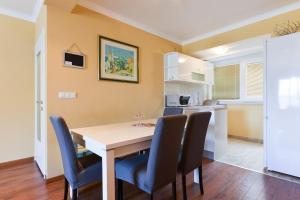 a kitchen and dining room with a table and chairs at VIVA RIVA ZADAR in Zadar