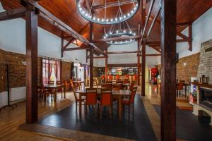 a dining room with wooden tables and chairs at Penzión Žemberovce in Dolné Žemberovce