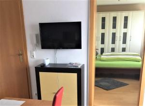 ショナッハにあるFerienwohnung Alexander Feissのテレビ、テーブル、椅子が備わる客室です。