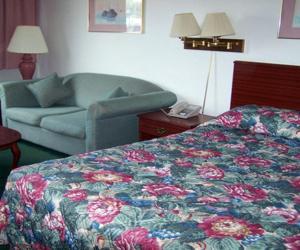 a hotel room with a bed and a couch at Harbor Inn in Philipsburg
