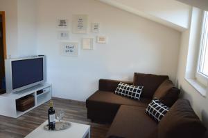 a living room with a couch and a tv at Apartment No. 121 in Rottweil