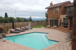 a swimming pool in the backyard of a house at Alyssa's Inn Boutique Guesthouse in Cape Town