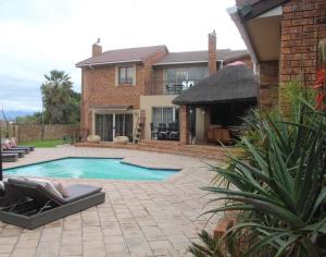 a swimming pool in the backyard of a house at Alyssa's Inn Boutique Guesthouse in Cape Town
