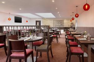 a dining room filled with tables and chairs at Ramada Bristol West in Easton in Gordano