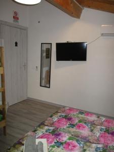 a bedroom with a bed and a flat screen tv on the wall at Palazzo Ruisi in Scordia +59 photos