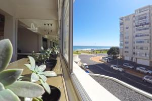 a balcony with plants and a view of a street at 205 New Cumberland in Cape Town
