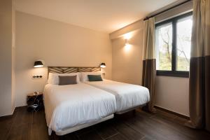 Voodi või voodid majutusasutuse Hotel Rural Sagarlore toas