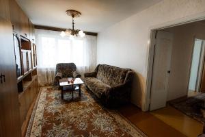 a living room with a couch and a table at Большая квартира на пр. МИРА in Salihorsk