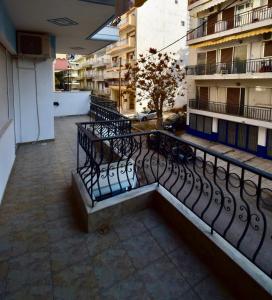 a balcony with a bench in a building at Feeling Home in Thessaloniki