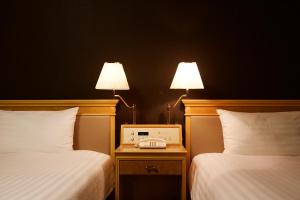 Rúm í herbergi á Hotel Agora Regency Osaka Sakai