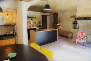 a kitchen and dining room with a table and chairs at Gite de Loup-Terre in Tours