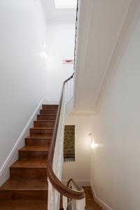 a staircase with white walls and wooden floors at naBaixa Apartments in Porto